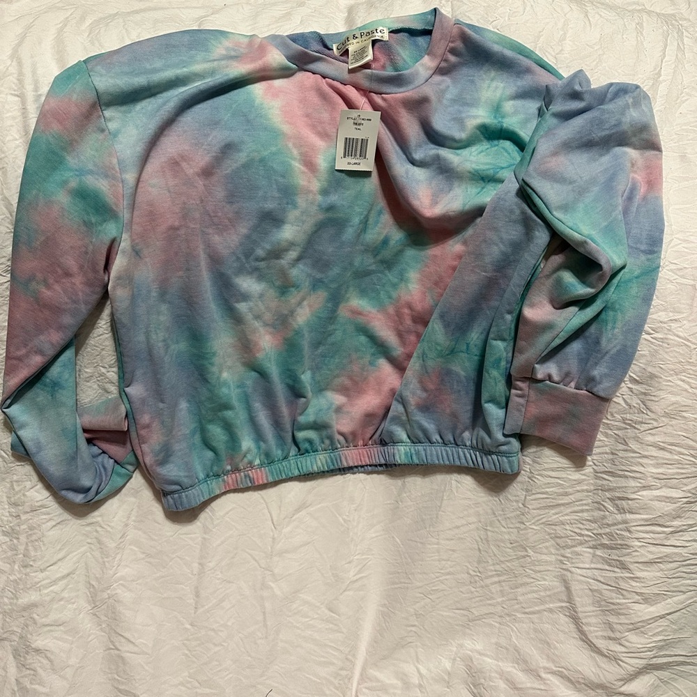 Cut-and-paste designed in California. Tie dye teal, and polyester.